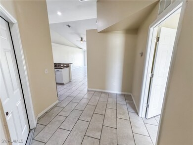 Hallway featuring visible vents, baseboards, light