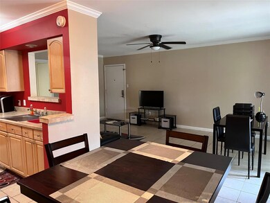 Dining space with sink, ornamental molding, ceilin
