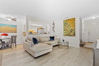 Living room with light wood finished floors, a ce