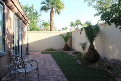 Fenced backyard with a patio
