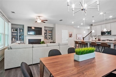 Dining area with dark hardwood / wood-style floori