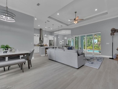 Living room featuring ceiling fan with notable cha