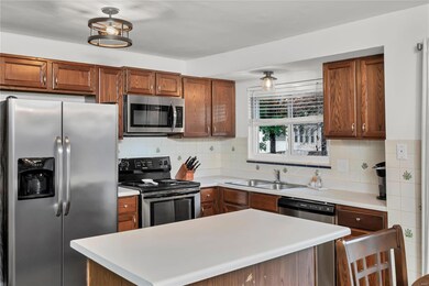Kitchen has center island, with breakfast counter,