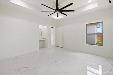 Unfurnished bedroom featuring light marble finish floors and ceiling fan