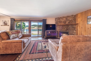 Living area featuring wood walls, a fireplace, and wood finished floors