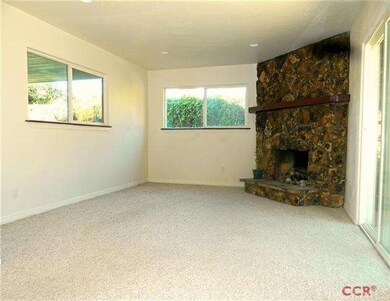 cozy family room with rock fireplace and patio acc