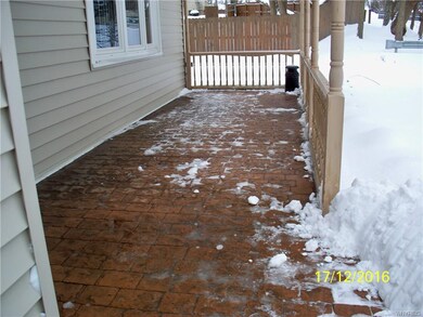 Stamped concrete covered front porch.