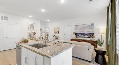 Kitchen with sink, light hardwood / wood-style flo
