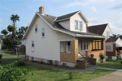 Side view of home.  The brick sidewalk goes from f