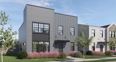 View of front facade featuring board and batten siding and a front lawn