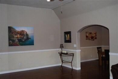 Rear of Living Room with Arched Opening to the Din