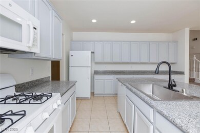 Kitchen with recessed lighting, white appliances,