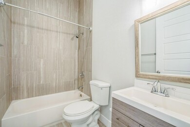 Full bath with toilet,  shower combination, and v