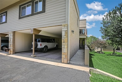 View of parking featuring a carport