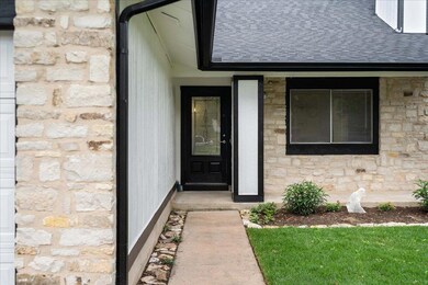 Property entrance featuring stone siding and roof