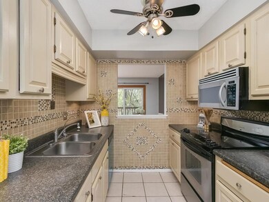 Bright kitchen with tile floor, backsplash and sta
