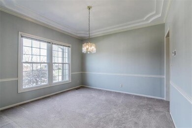 Formal dining room with wainscoting and coffered c