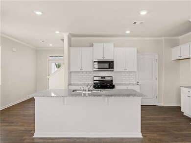 Kitchen with stainless steel appliances, light sto