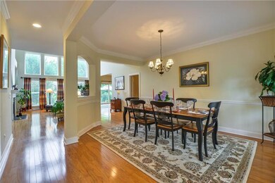 The expanse of hardwoods sweep from front door, dining, living and kitchen areas.