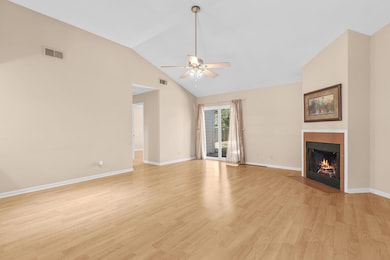 Unfurnished living room with a ceiling fan, a fir