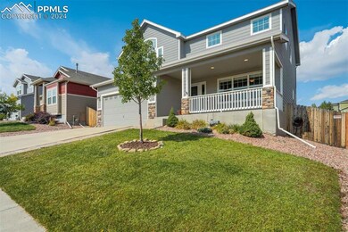 View of front of home with a garage, a front lawn,