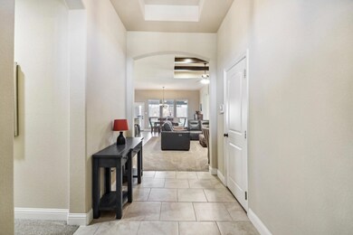 Hall featuring light tile patterned floors