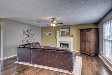 Family room w/ hardwood floors and gas fireplace.