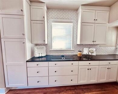 Kitchen - newer cabinets, natural stone countertop