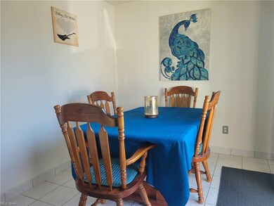 The dining area features ceramic tile floors.