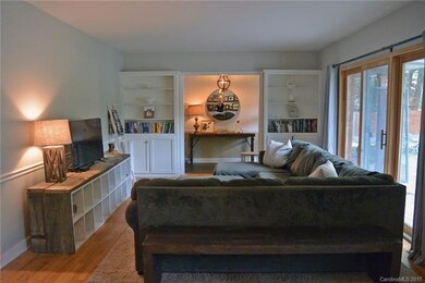 Living room with built ins and sliders to back