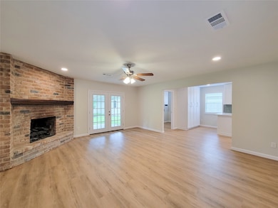 spacious open concept living room with brick firep