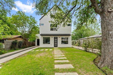 View of front of home with fence and a front yard