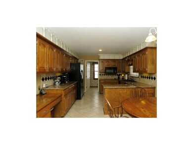 Plenty of cabinetry with laundry room in rear.