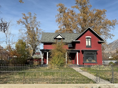 View of front of house with a fenced front yard and brick siding