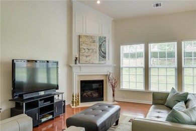 The great room has vaulted a ceiling, wall of windows that overlook the back yard and that bring in beautiful light, beautiful woodwork around the fireplace with marble surround.