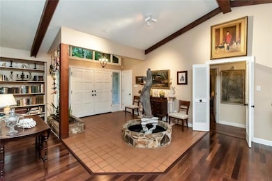 Entryway with vaulted ceiling with beams and wood 