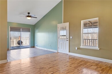 Open living area with cathedral ceiling.