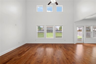 The two-story great room features ample windows to