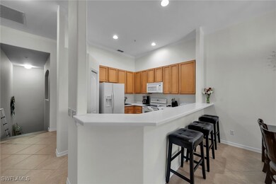 Kitchen featuring visible vents, a kitchen bar, wh