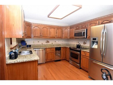 The eat-in kitchen features granite countertops an