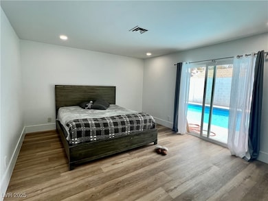 Bedroom featuring baseboards, access to outside, w