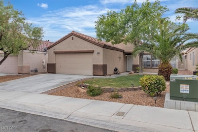 Mediterranean / spanish-style house with a garage, stucco siding, a tiled roof, and concrete driveway