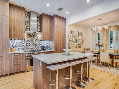 Kitchen with wall chimney range hood, high end st