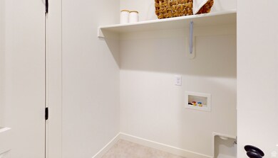 Laundry room featuring washer hookup and baseboards