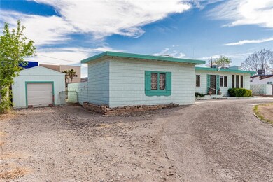 Ranch-style home with driveway, an outbuilding, an