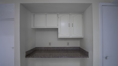The versatile nook adjacent to the kitchen is perfect for a home office or homework station.