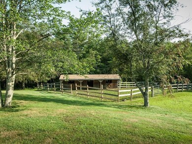 The stall horse barn and fenced in...
