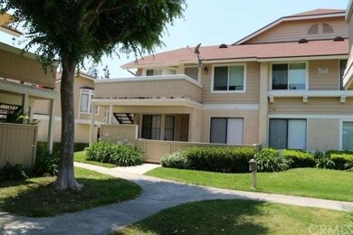 End unit condo with lush landscaping and shade tre