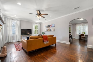 Living room featuring ceiling fan, visible vents, 
