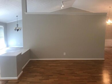 Unfurnished dining area with vaulted ceiling, wood